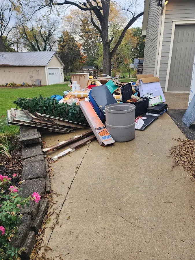 Dumpster being loaded with debris for 12 Yard Dumpster Rental in Tupelo